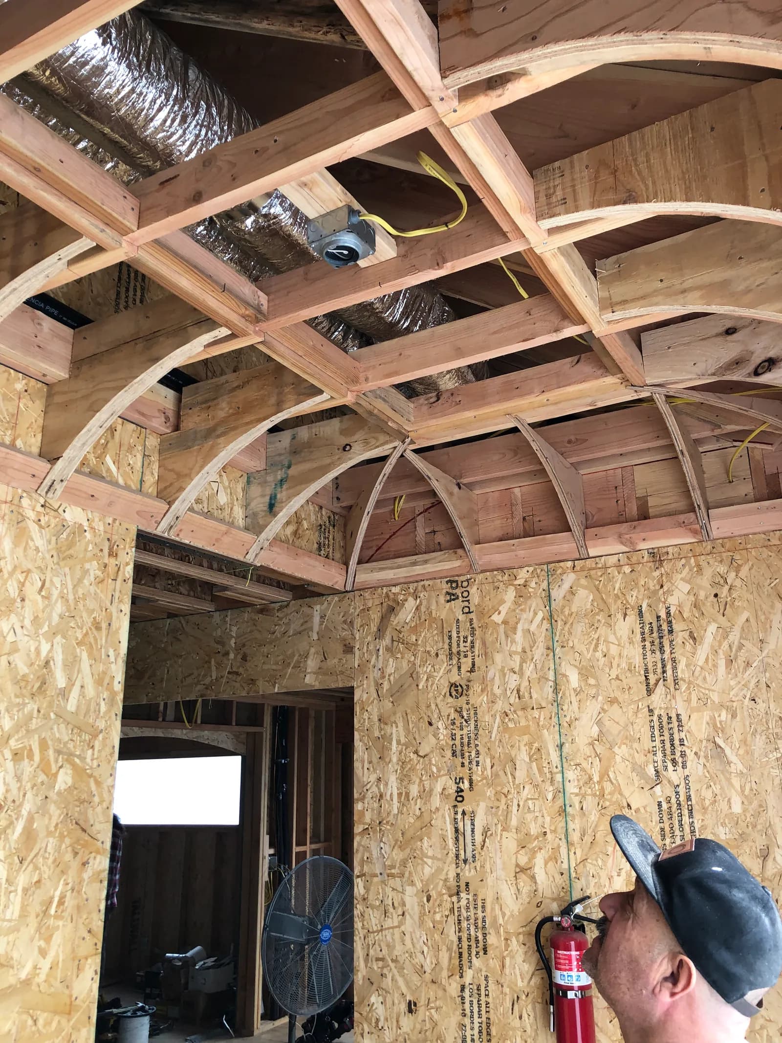 A barrel-vaulted ceiling in exposed timber framing, insulated between the ribs.